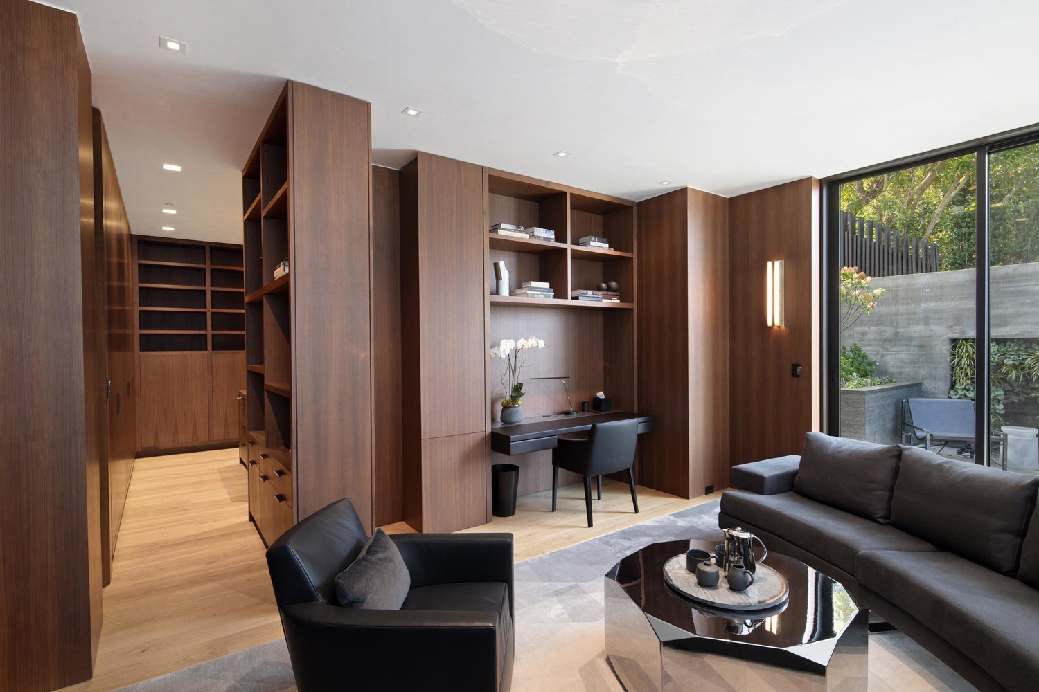 Custom walnut cabinetry and a quiet garden-facing sitting room