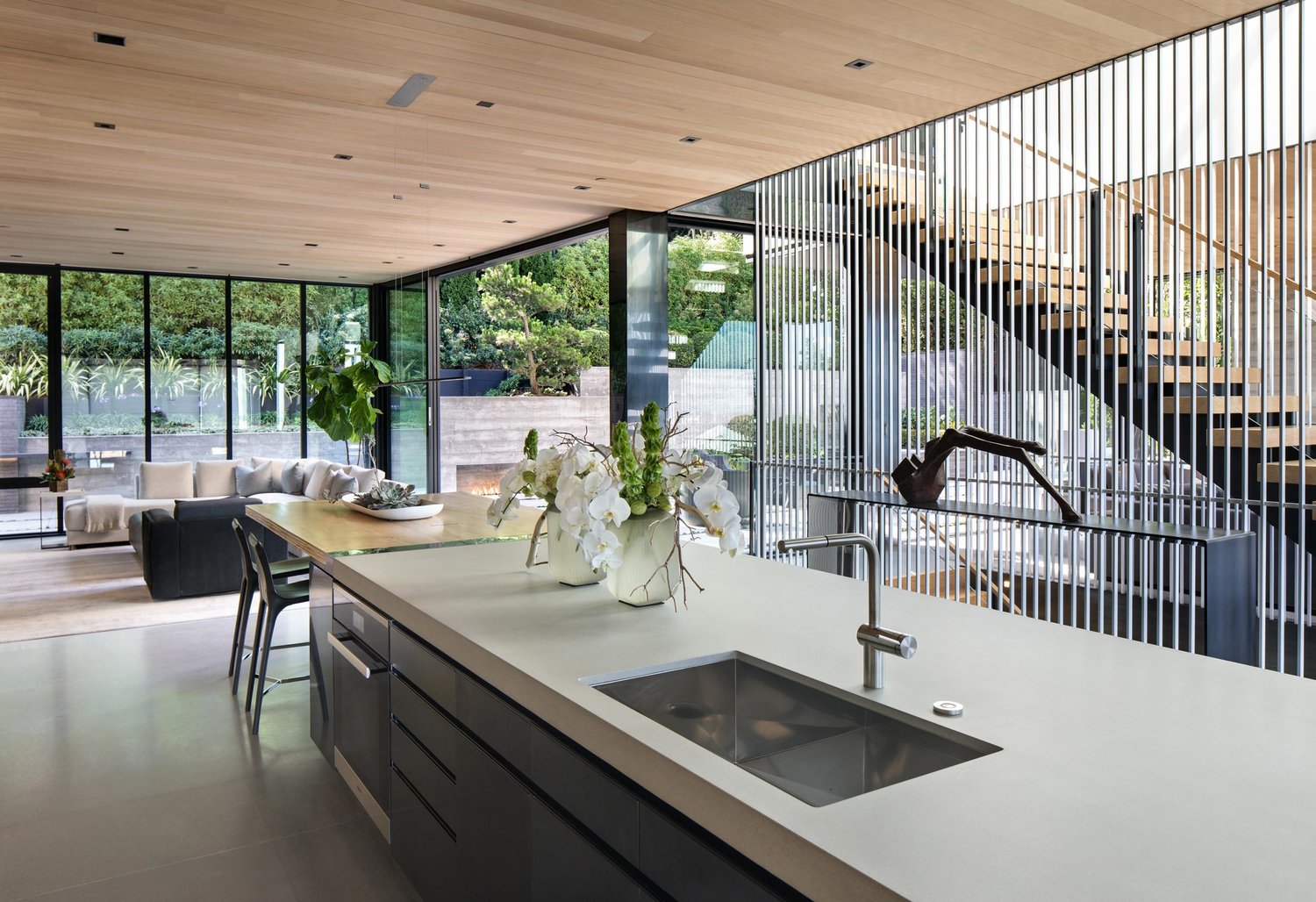 Open kitchen with oak ceilings, fine metalwork, and views to the garden