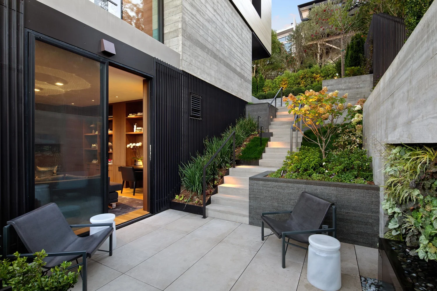 Terraced garden and concrete steps leading to a private courtyard