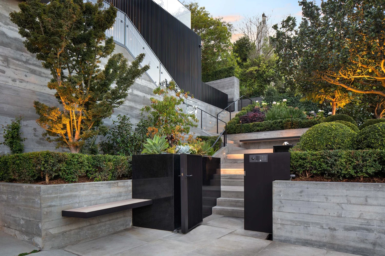 Carefully detailed concrete terraces, native planting, and integrated lighting
